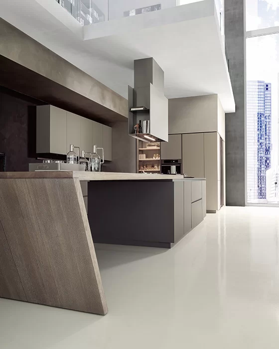 Modern Materika kitchen with a 30-degree inclined wood island edge, sleek technical cabinetry, and integrated hood system.